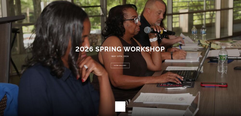 Three individuals sitting at a table looking at various paperwork and computers. The words 2026 Spring Workshop, May 13th, 2026 is written across the photo.