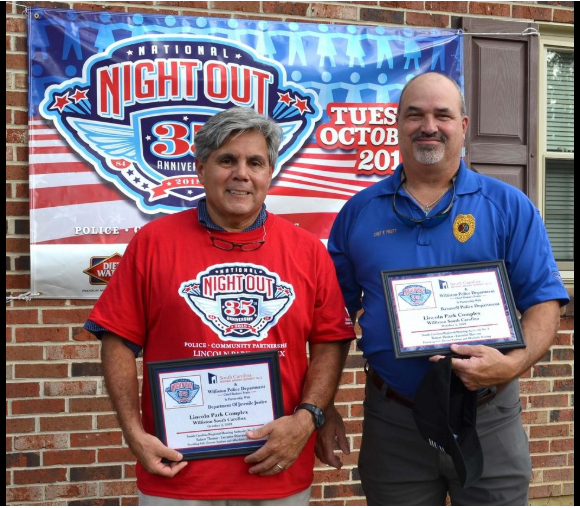 Two gentlemen posing with awards for the SC Region 3 Housing Authority Night Out.